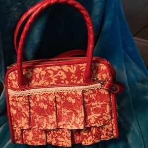 Patricia Nash leather wrist carry or cross body pocket book.